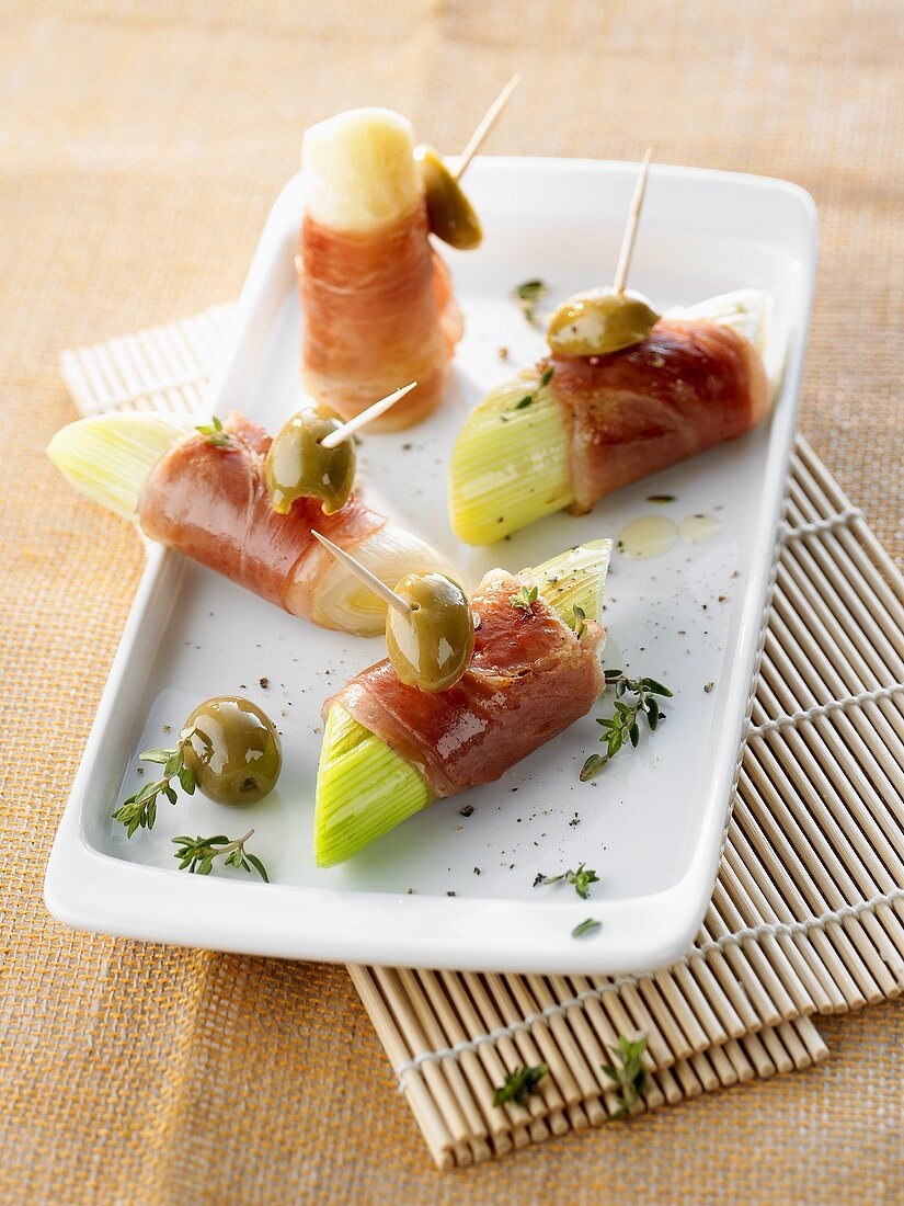 Pieces of leek wrapped in ham