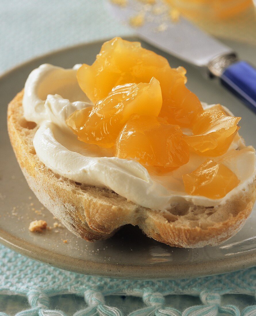 Passion fruit and orange jelly on a roll with fresh cheese