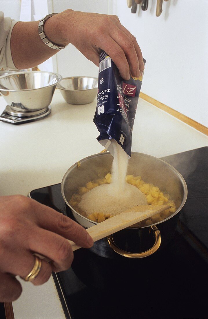 Adding preserving sugar to fruit in pan 