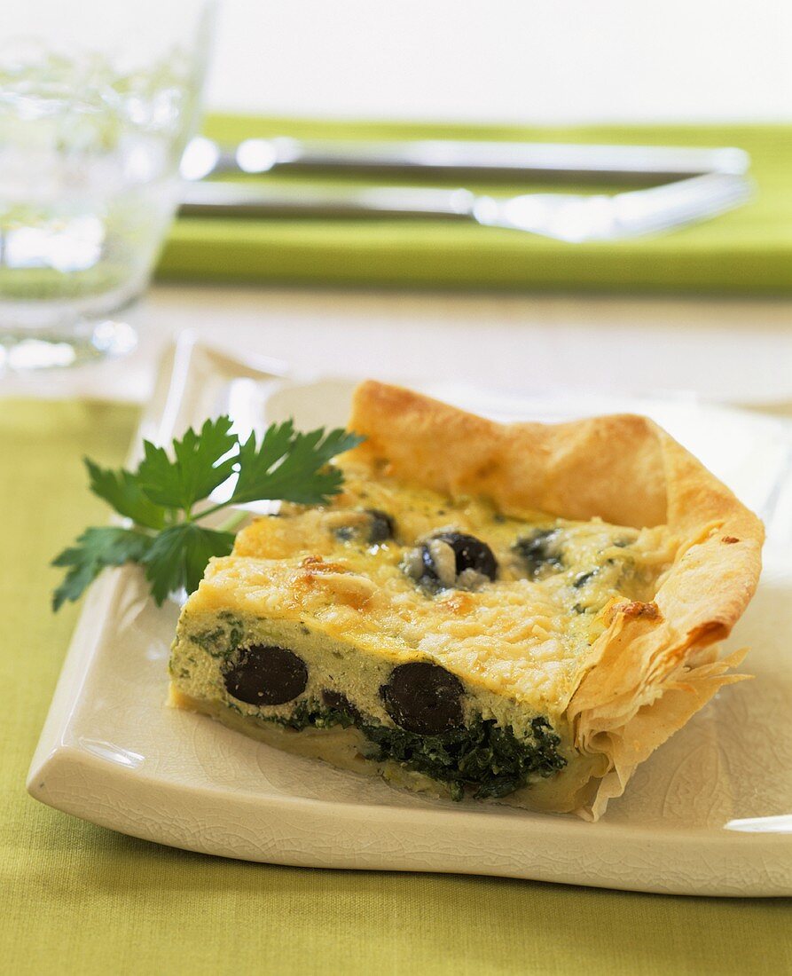 Piece of spinach, sheep's cheese and olive tart
