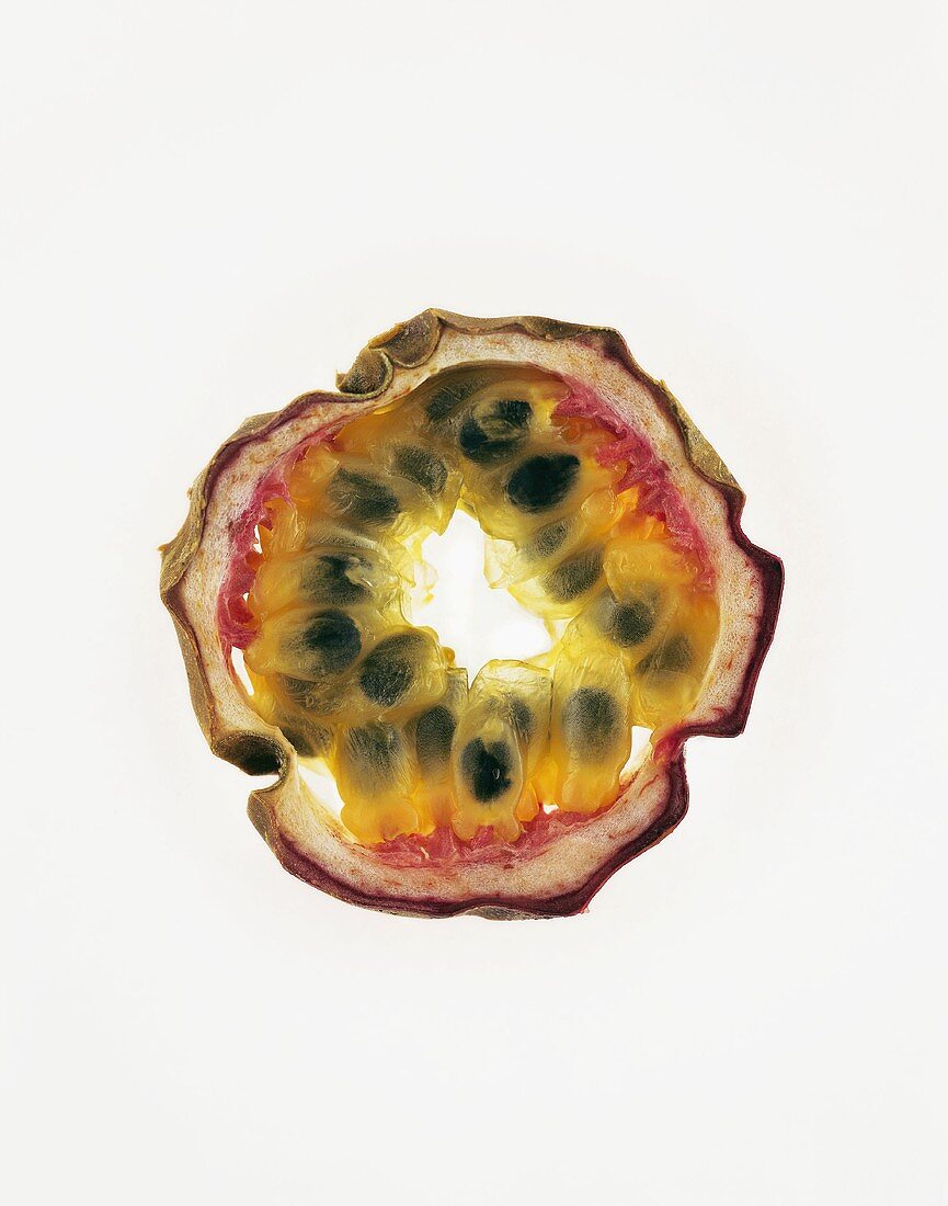 Slice of passion fruit, backlit