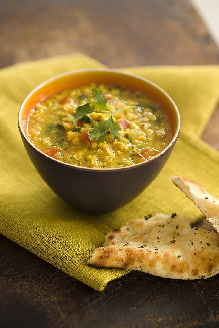 A bowl of curried lentil soup with coriander