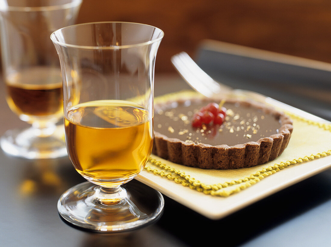 Small chocolate tart beside dessert wine