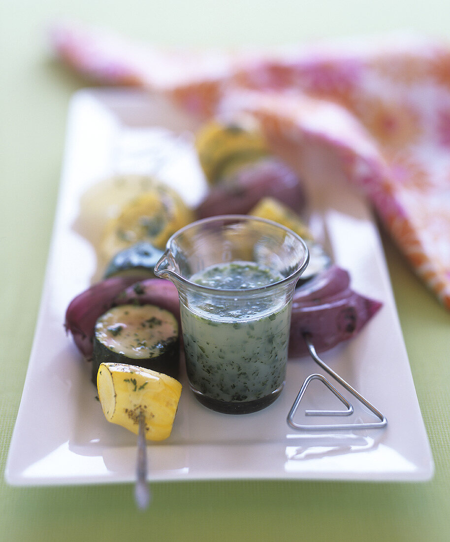 Vegetable kebabs and lemon and honey sauce with herbs