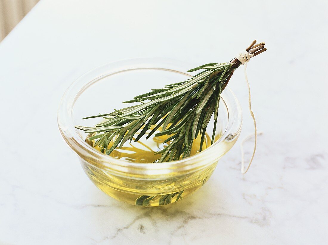 Rosemary oil in small glass bowl
