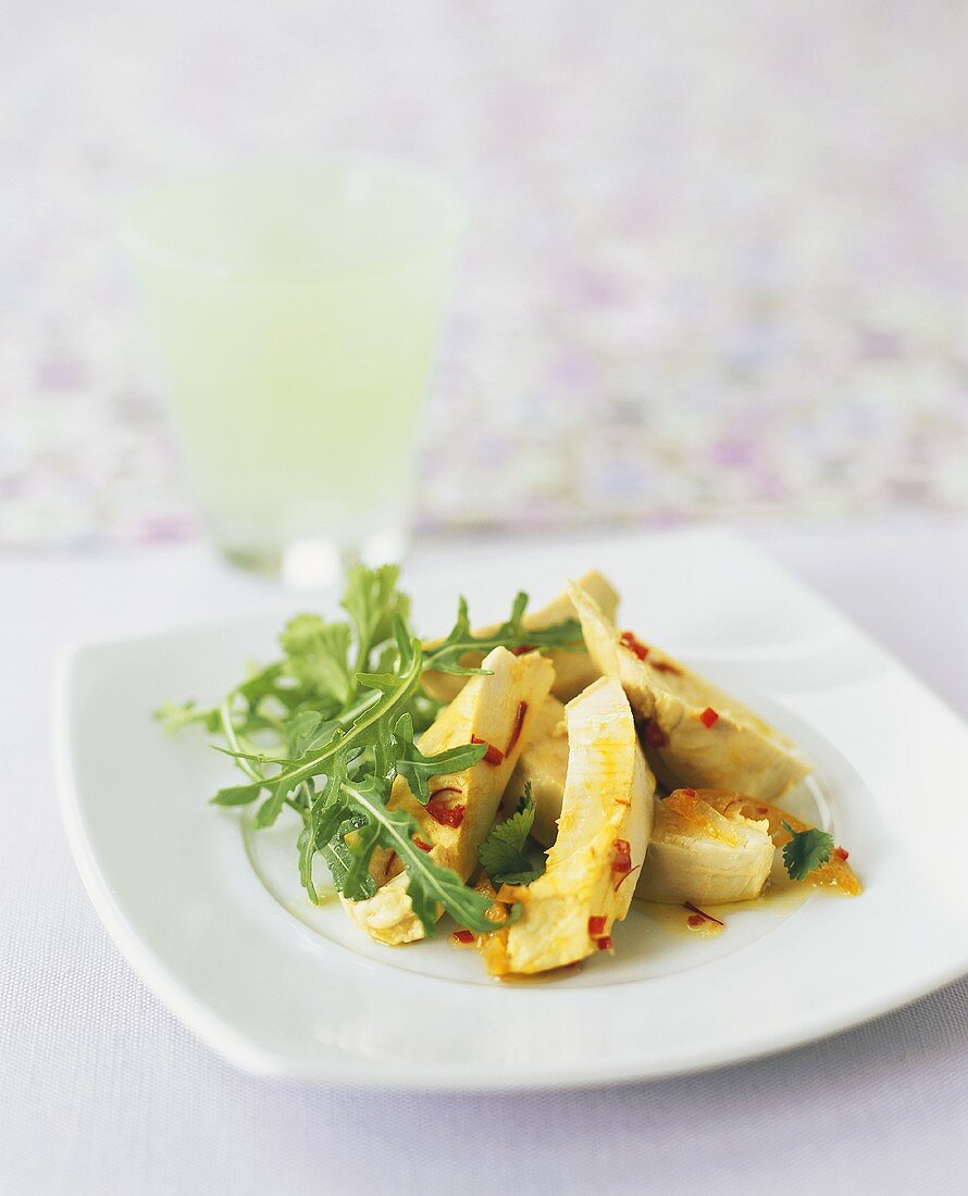Chicken salad with saffron and chili dressing and rocket