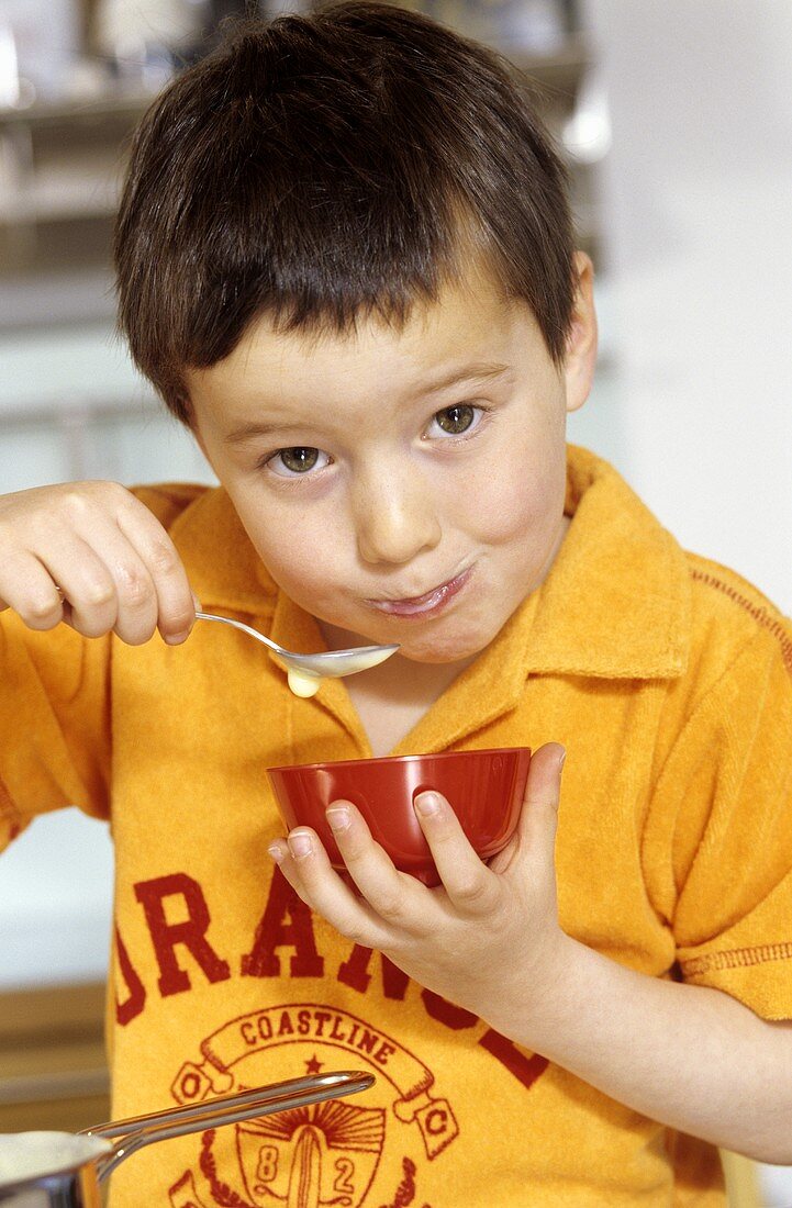 Boy eating pudding
