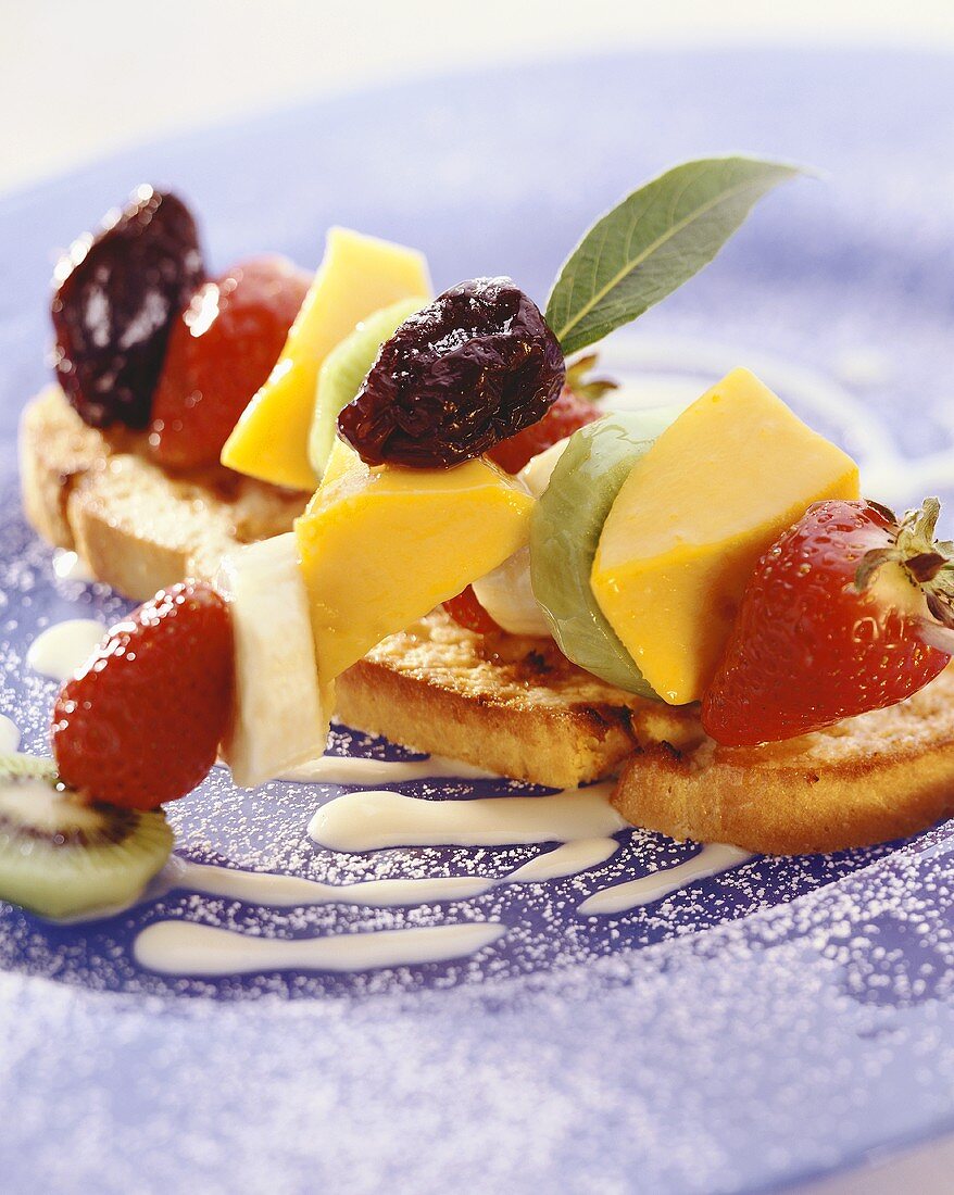 Skewered fruit on toasted white bread