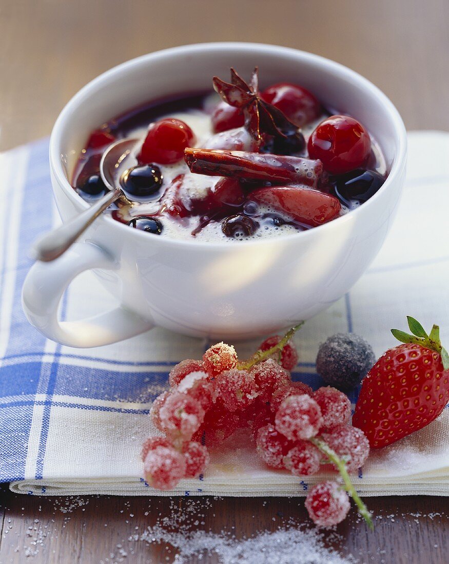 Red berry compote with vanilla cream in a cup