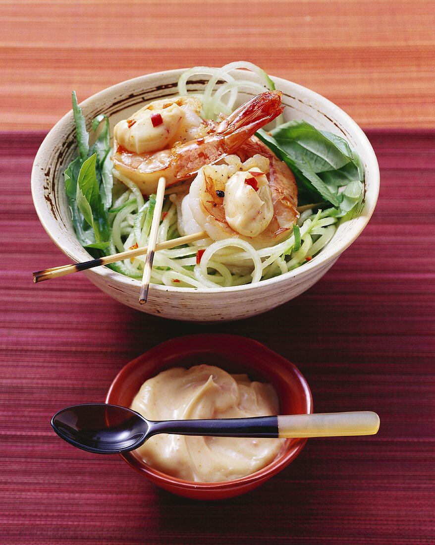 Fried prawns with chilli mayonnaise on strips of cucumber