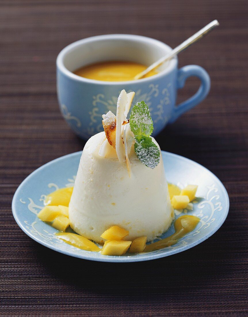Turned-out sour cream mousse with mango & pineapple sauce