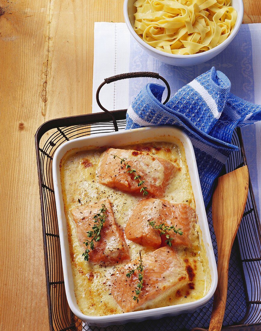 Salmon fillets au gratin and a bowl of ribbon pasta