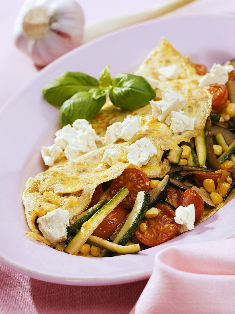 Omelette filled with summer vegetables and sheep's cheese