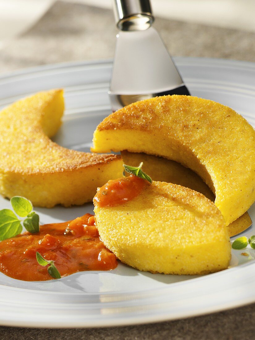 Polenta slices with tomato sauce