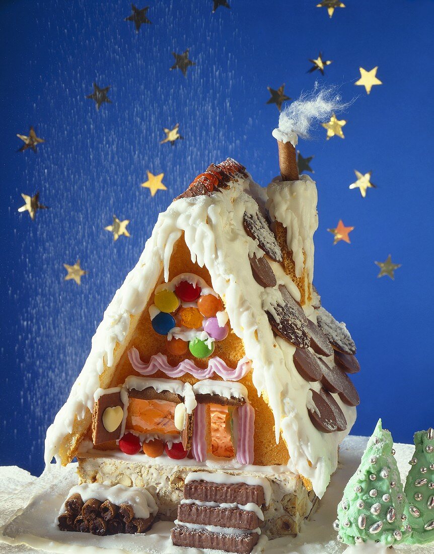 Icing sugar snow falling onto a gingerbread house