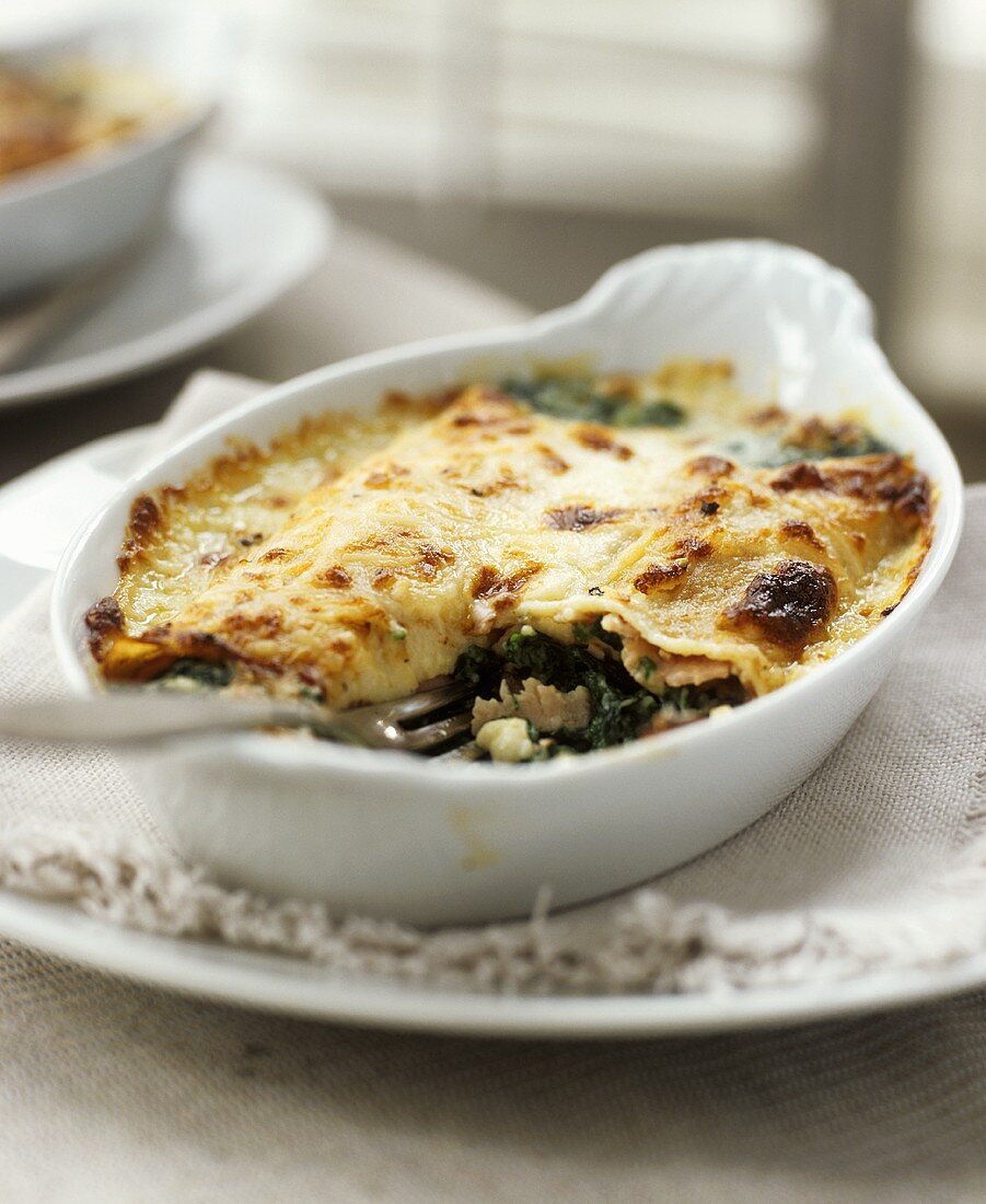 Savoury fish and spinach bake in a baking dish