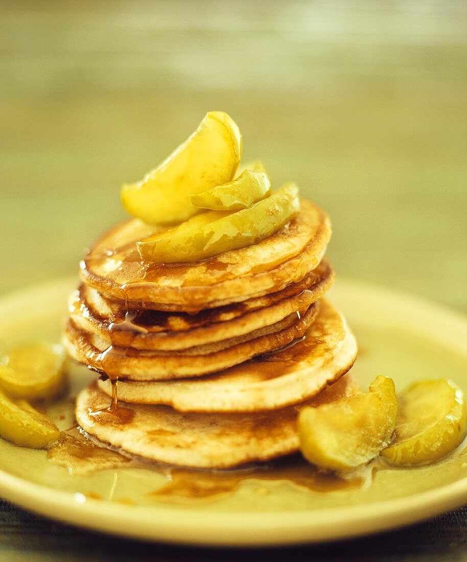 Pancakes with apple wedges and maple syrup
