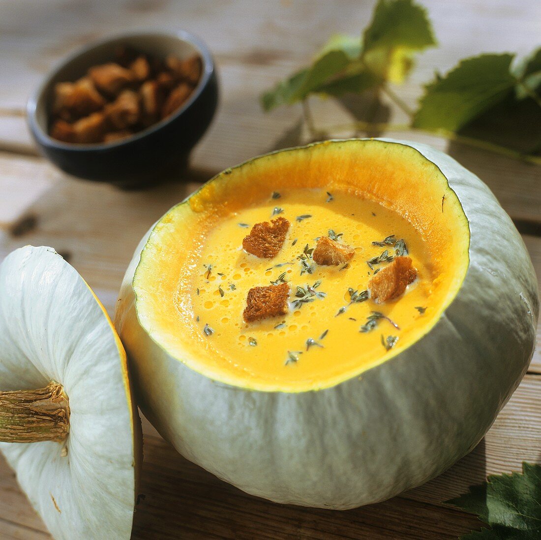 Pumpkin cream soup served in hollowed-out pumpkin