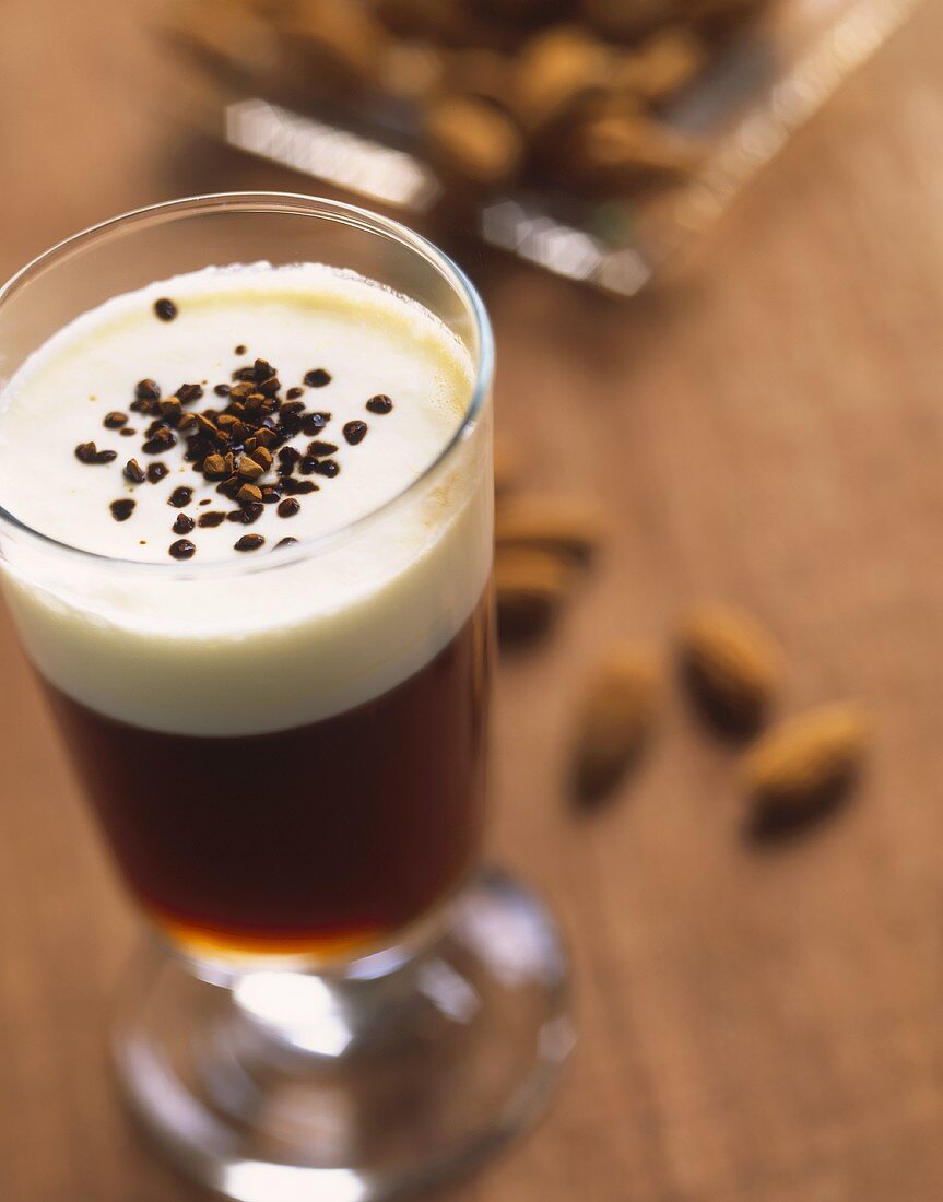 Almond coffee in glass (Coffee with almond syrup & milk froth)