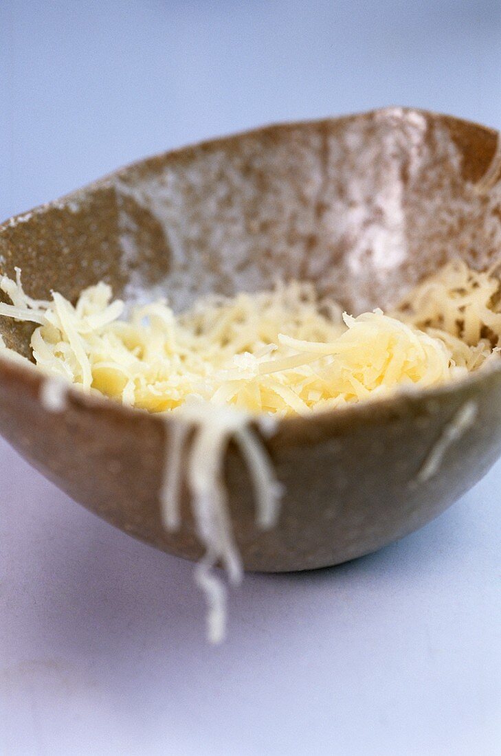 Grated cheese in a small bowl