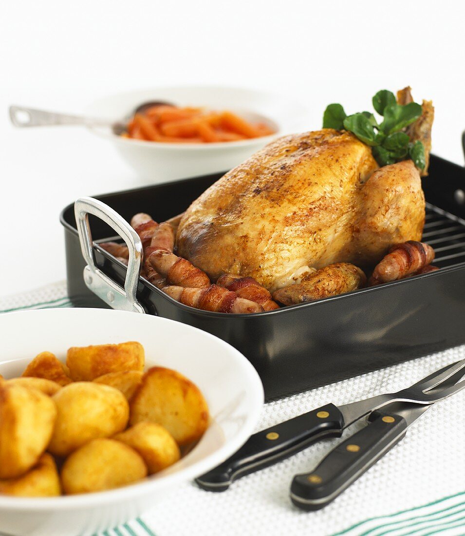 Roast chicken with potatoes and sausages