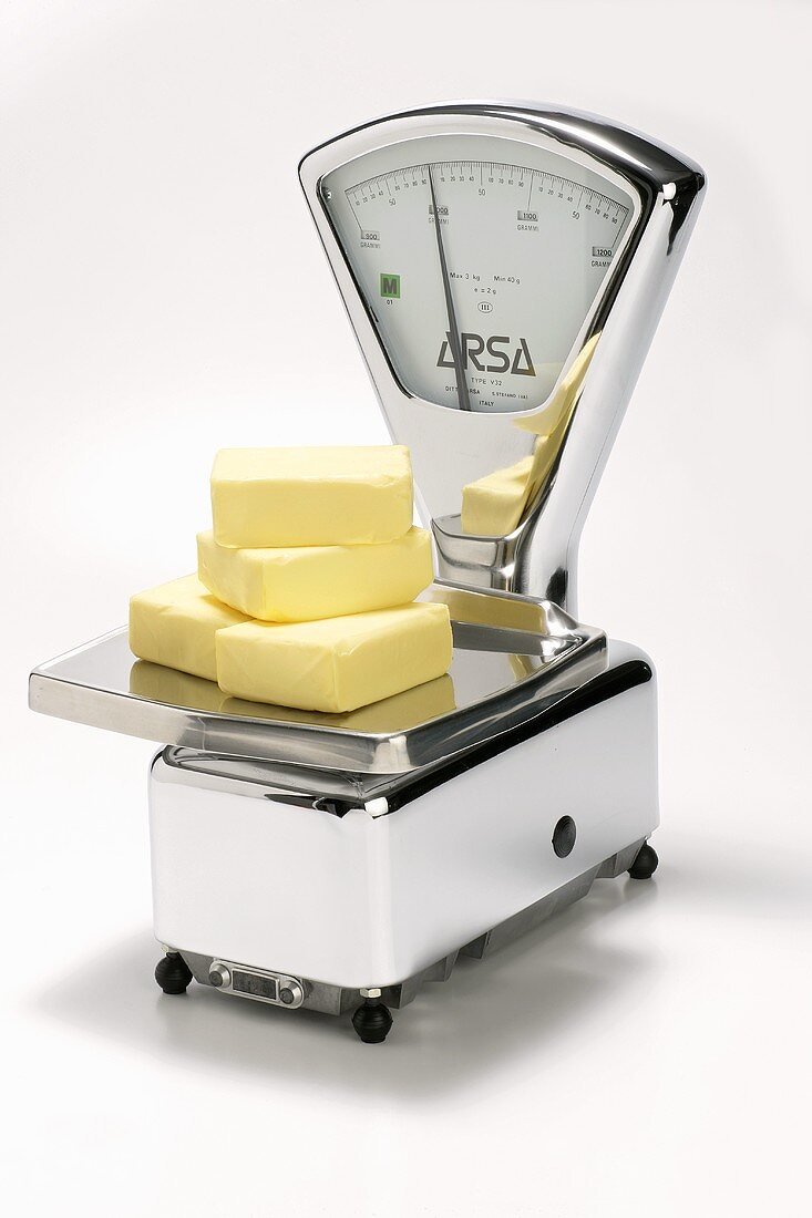 Four pieces of butter on scales