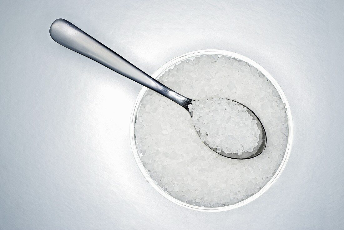 Sea salt in a small bowl with spoon