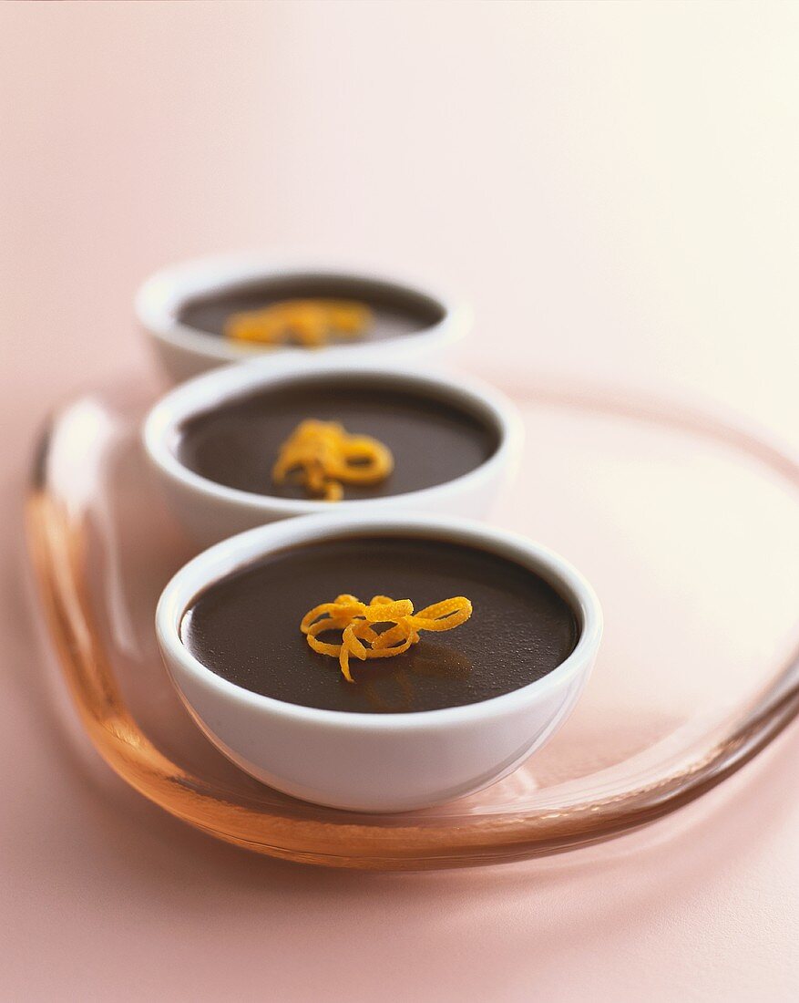Three chocolate puddings with orange zest