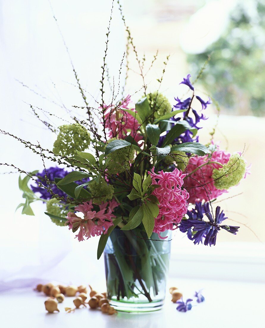 Hyacinths, viburnum and spiraea in glass