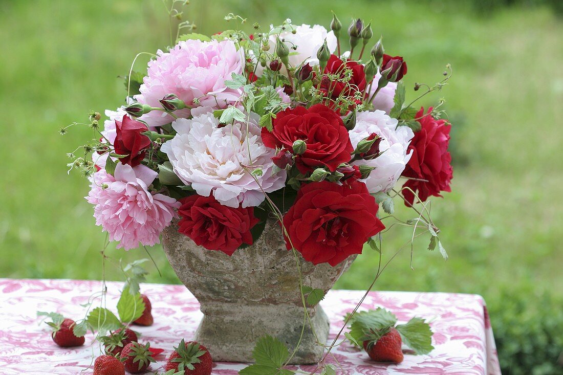 Arrangement of roses, peonies and wild strawberries