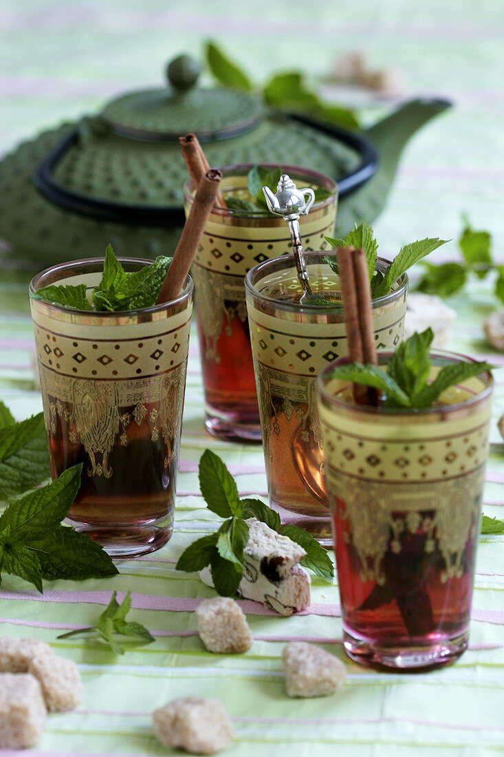 Peppermint tea with cinnamon stick in Moroccan glasses