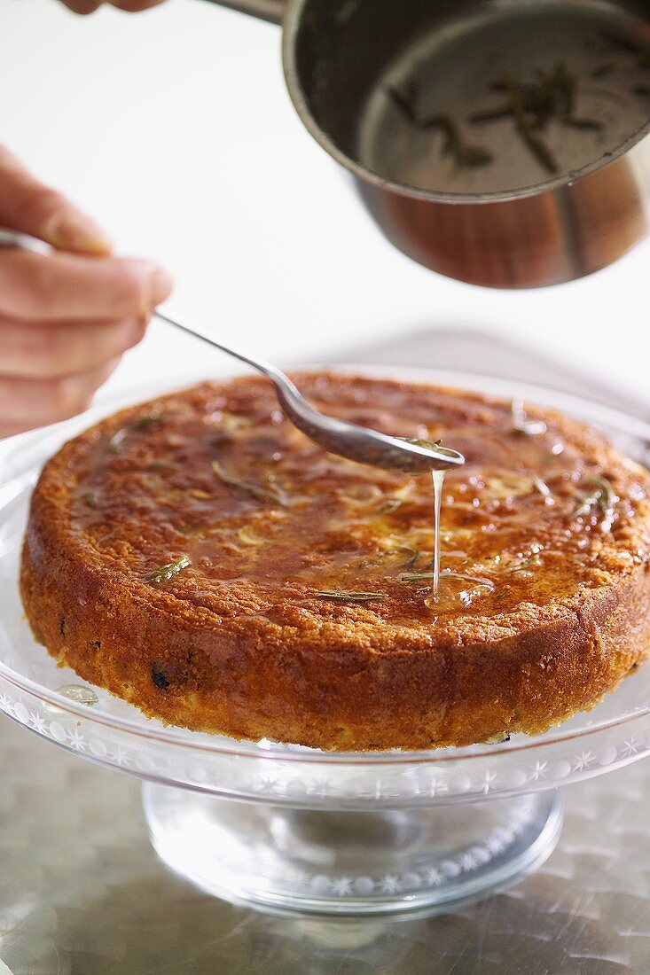 Sprinkling ricotta cake with rosemary syrup