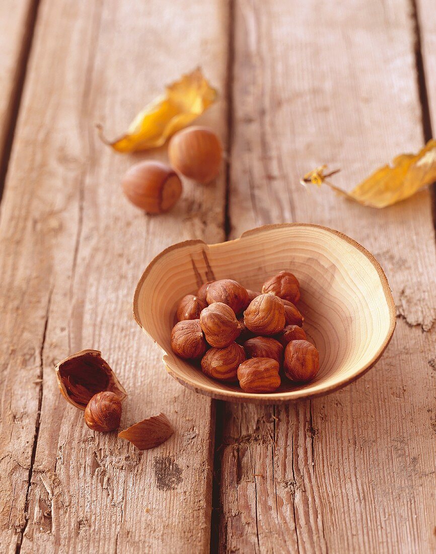 Shelled hazelnuts in a wooden bowl