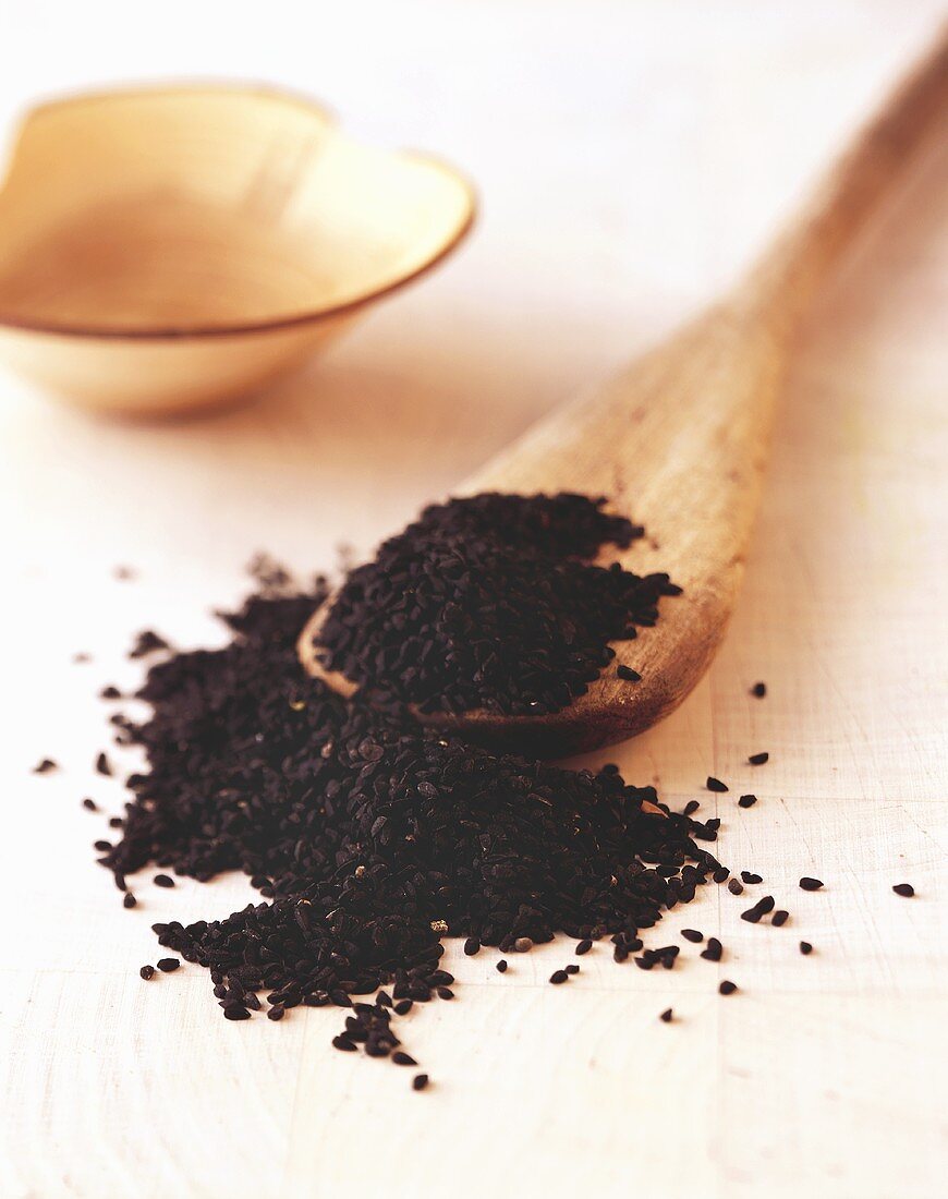 Black cumin with wooden spoon