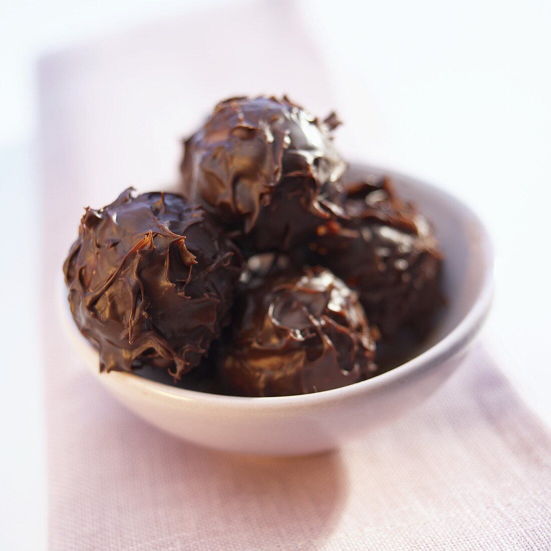 Several chocolate truffles in a bowl