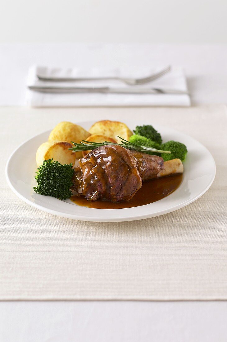 Lamb shank with potatoes and broccoli