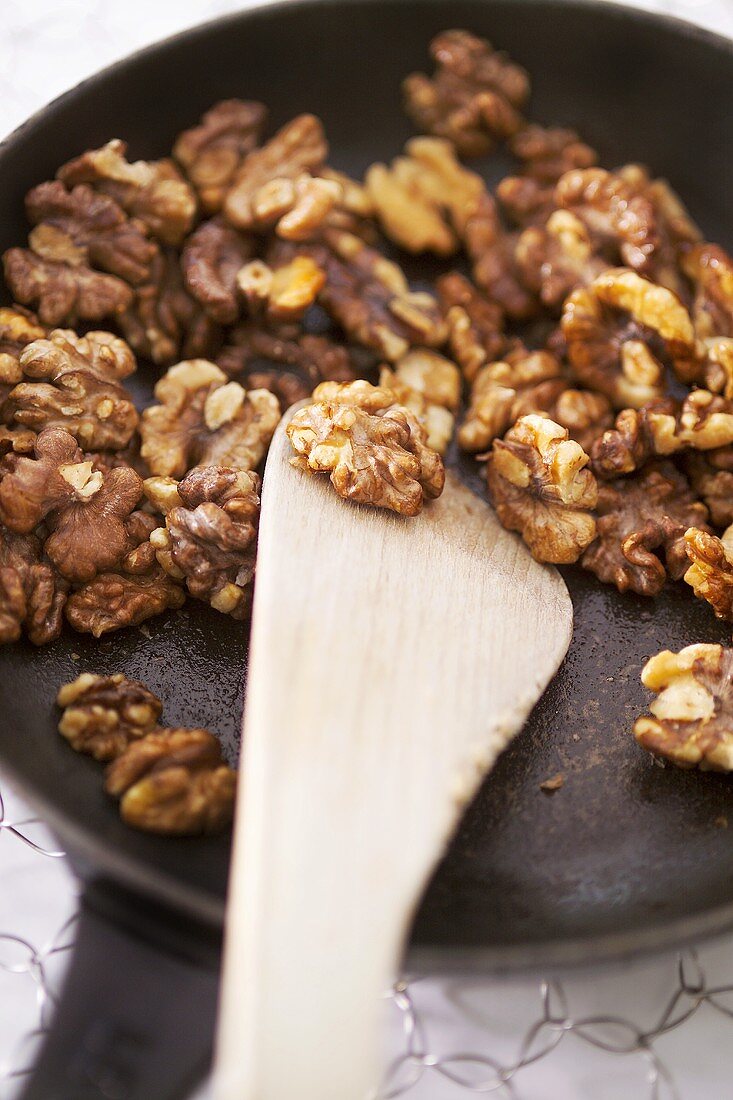 Toasting walnuts in a frying pan