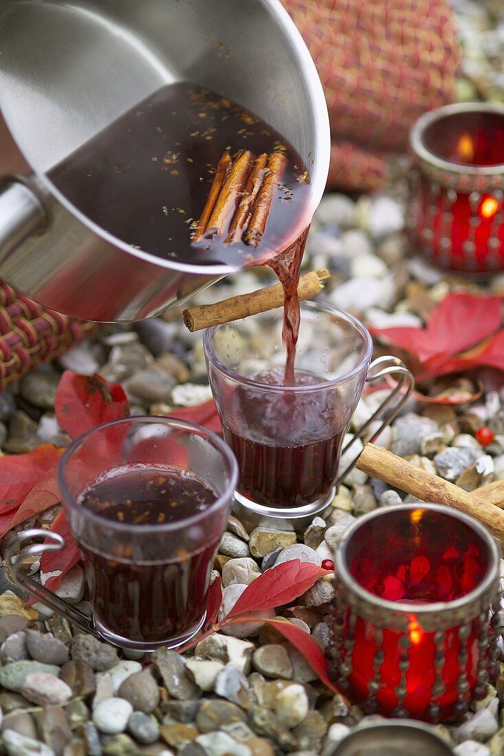 Pouring mulled wine into glasses