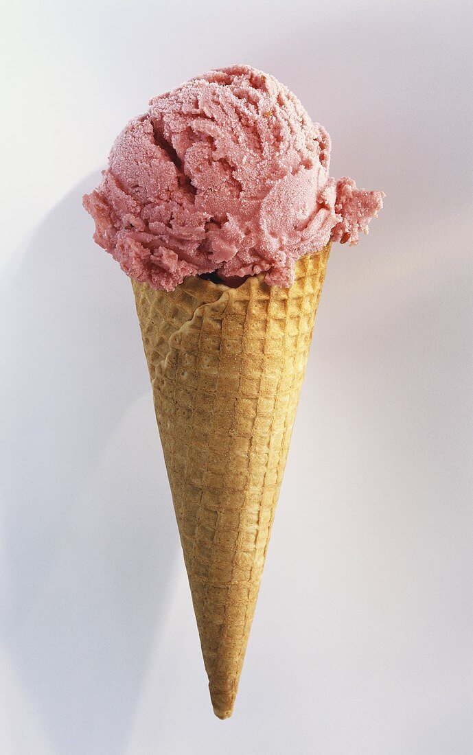 An ice cream cone with a scoop of raspberry ice cream