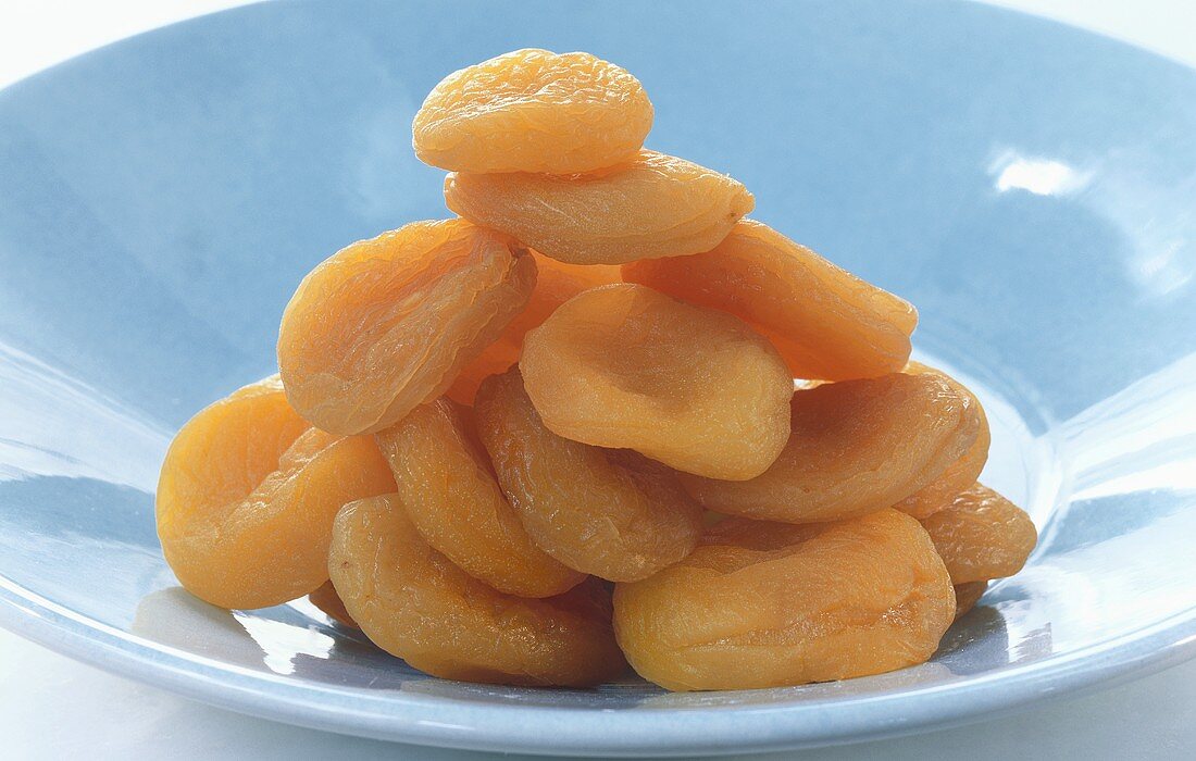 Several dried apricots in a dish