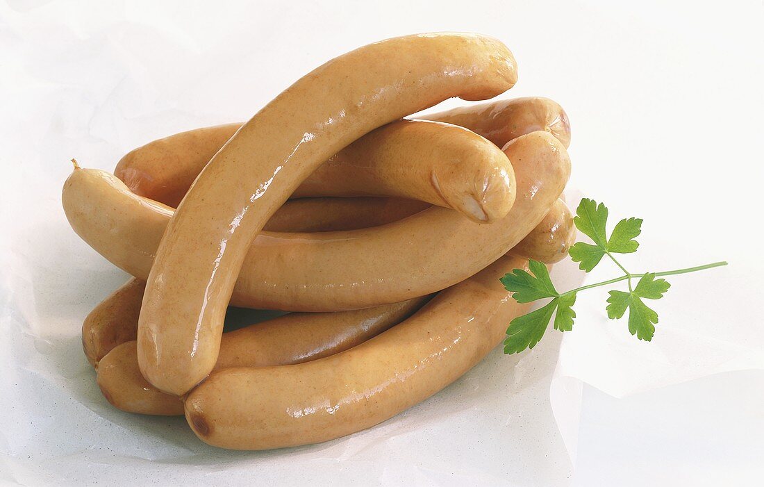 A heap of frankfurters on white background