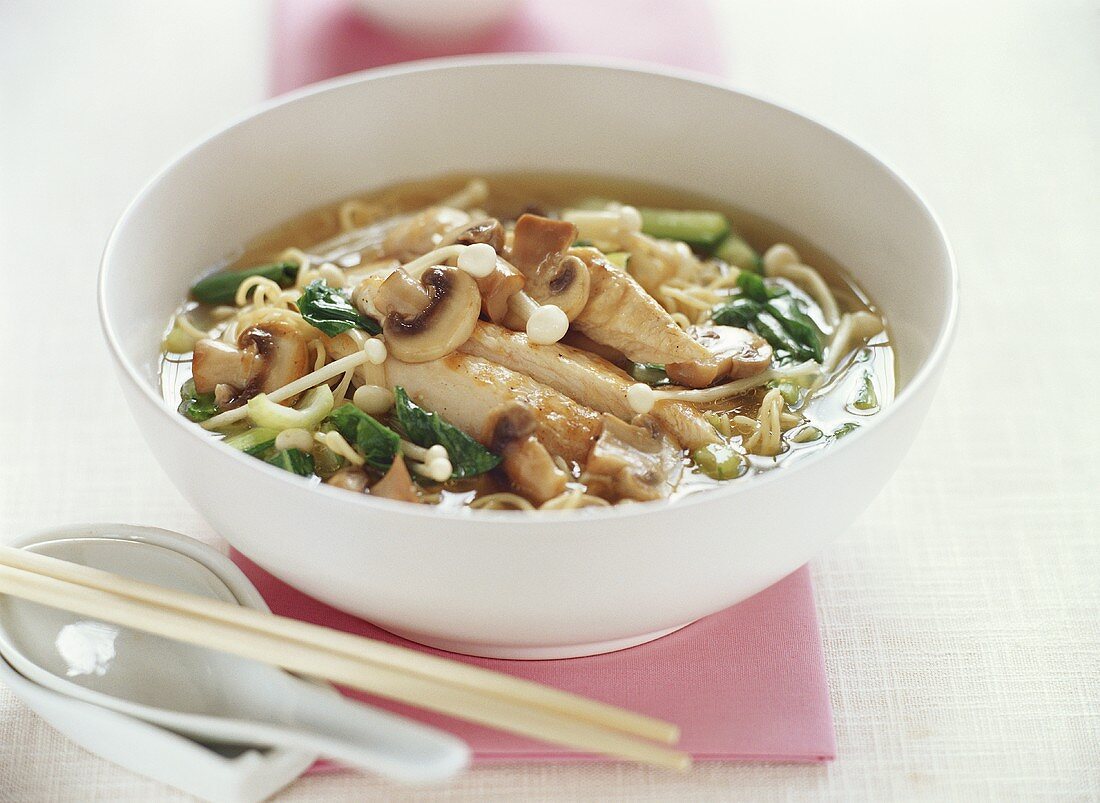 Asian noodle soup with chicken and mushrooms