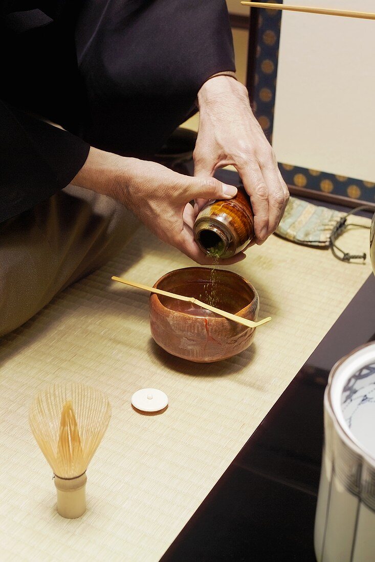 Tea master at tea ceremony, matcha tea powder