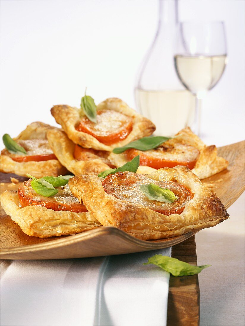 Puff pastry slices with tomato and basil