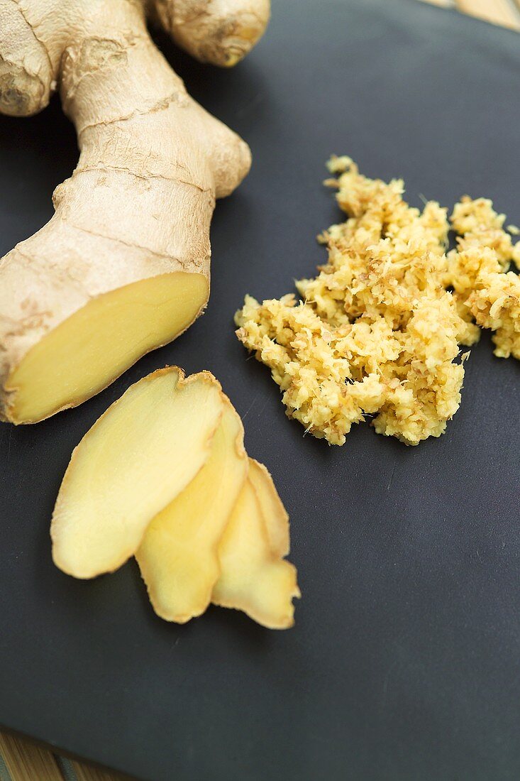 Fresh ginger root in slices and grated