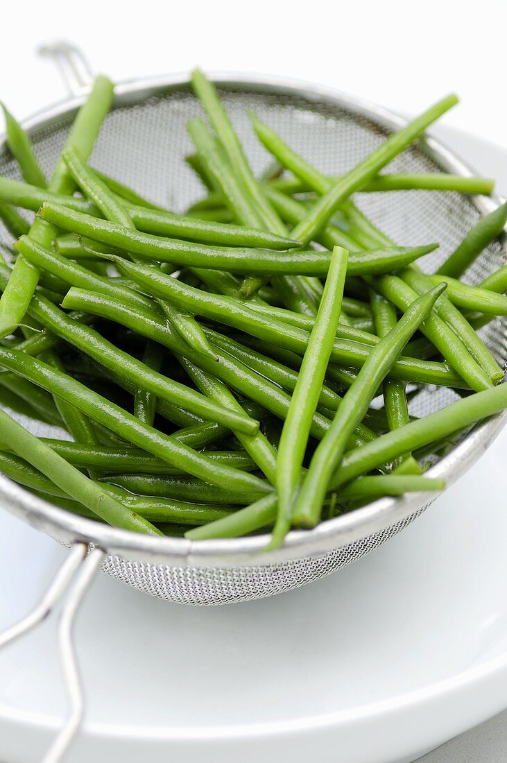 Blanched beans in a sieve