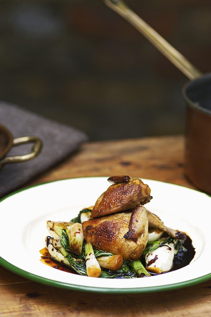 Smoked quail with pak choi and spring onions