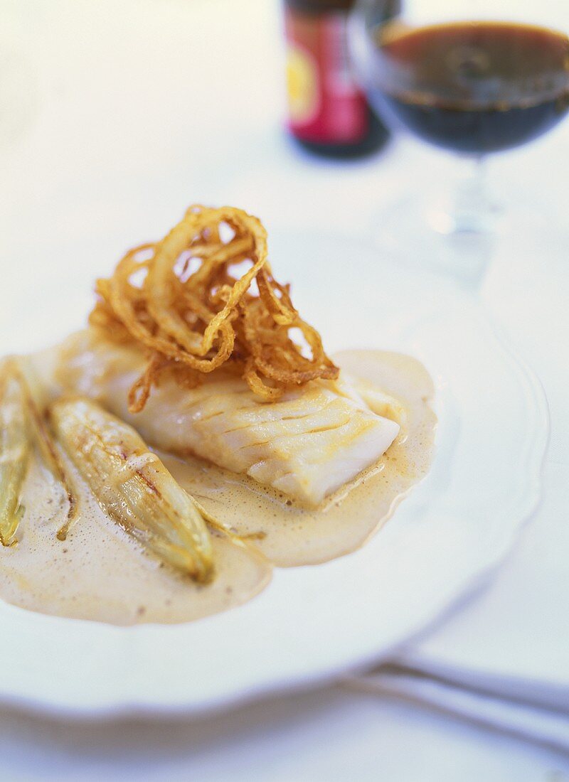 Cod with fried onions, beer sauce and chicory