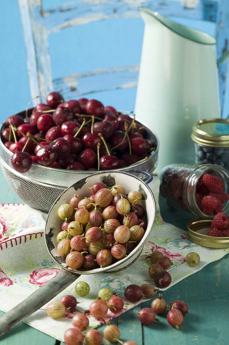 Berries and cherries with milk jug