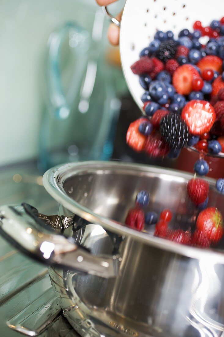 Tipping fresh berries into a pan